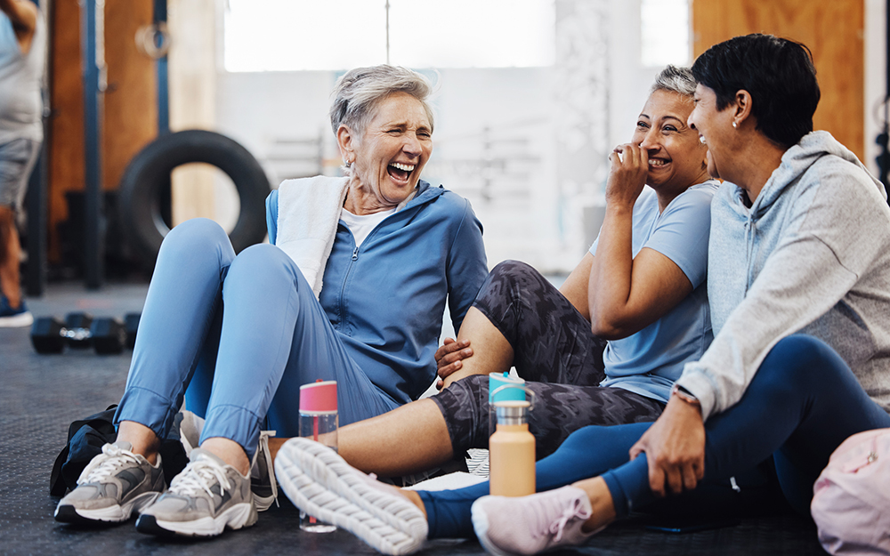 Mature women at the gym laughing together