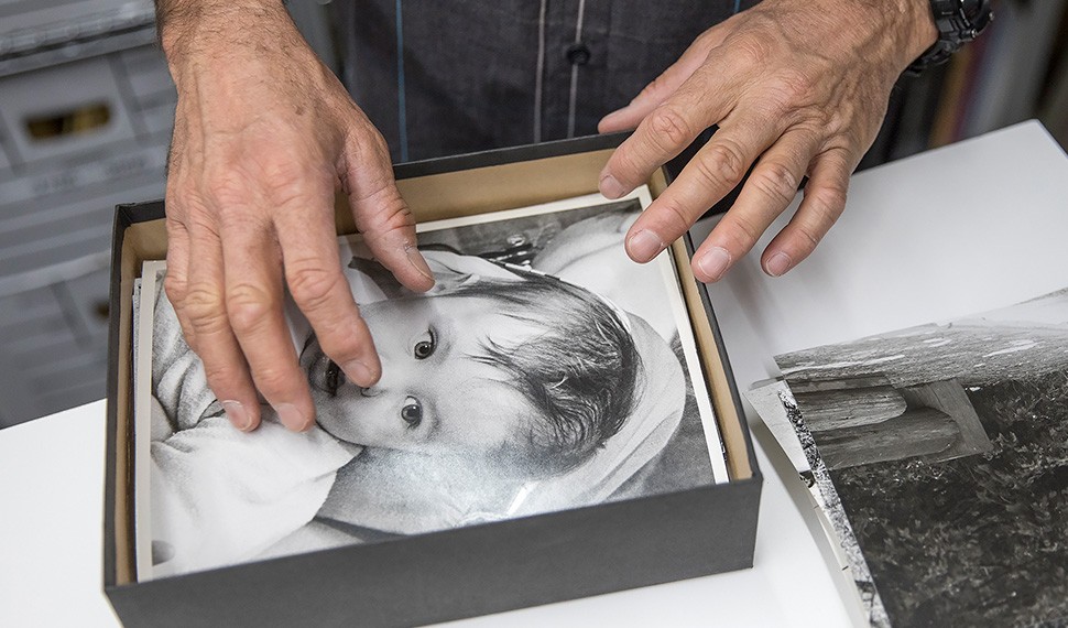 Leigh Wiener’s son Devik examines the images in his father's archives, including this photo of himself as a baby.