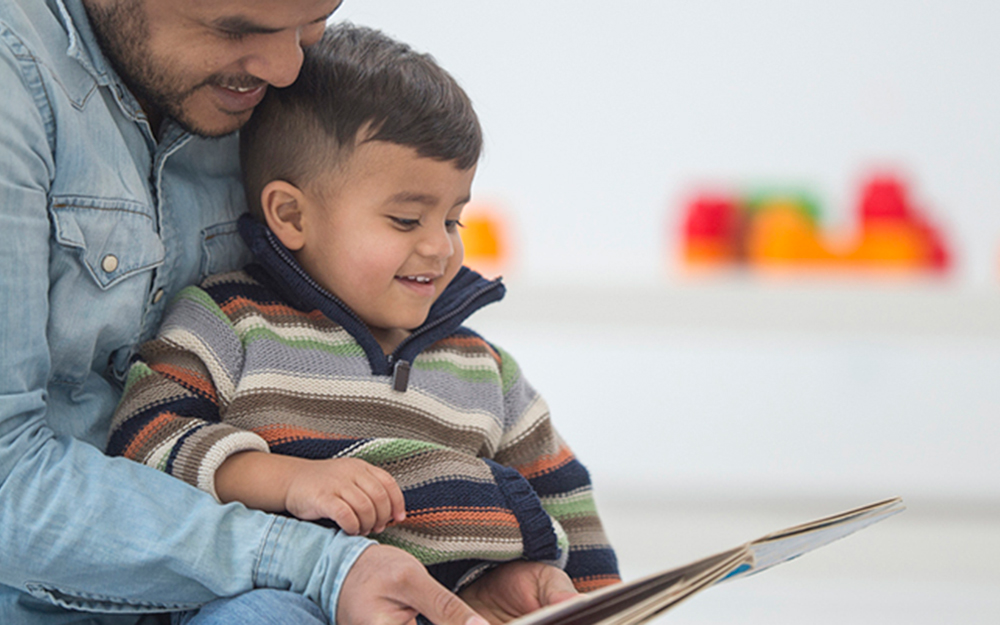 A man and a child reading a book