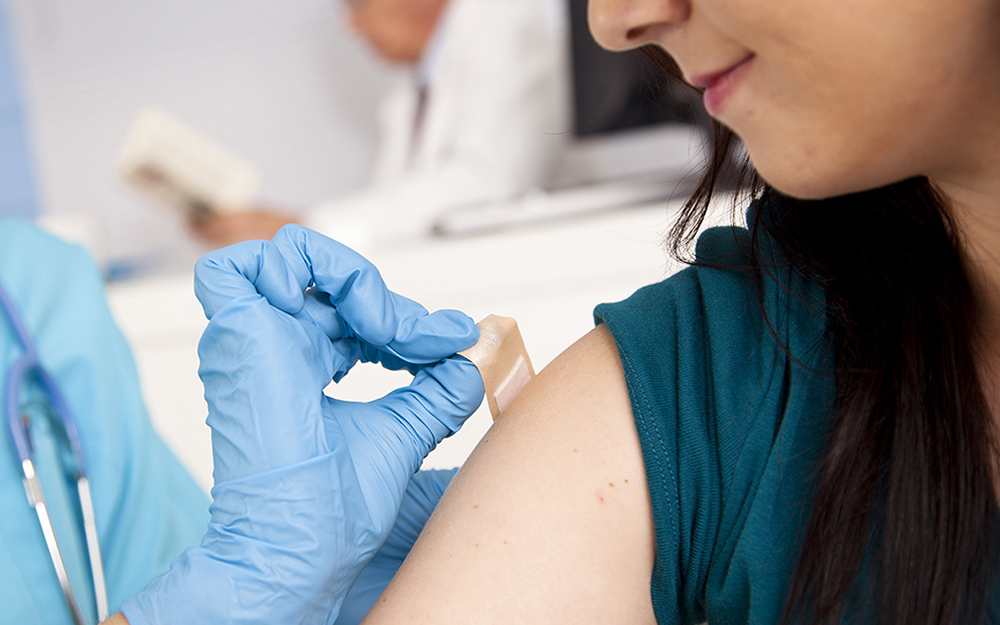 Nurse at pharmacy clinic vaccinating a patient.