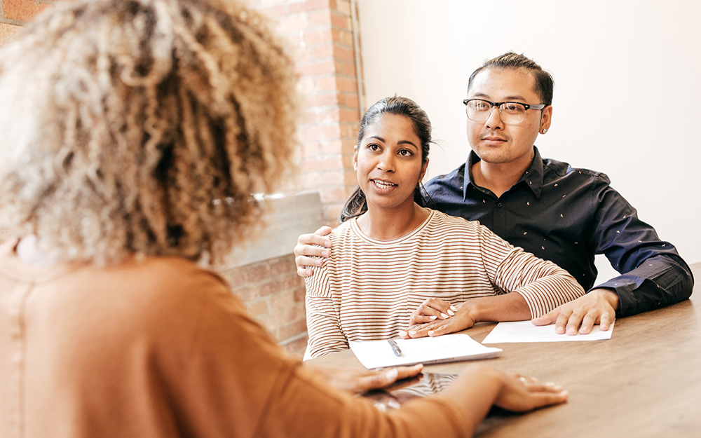 Couple speaking with fertility specialist.