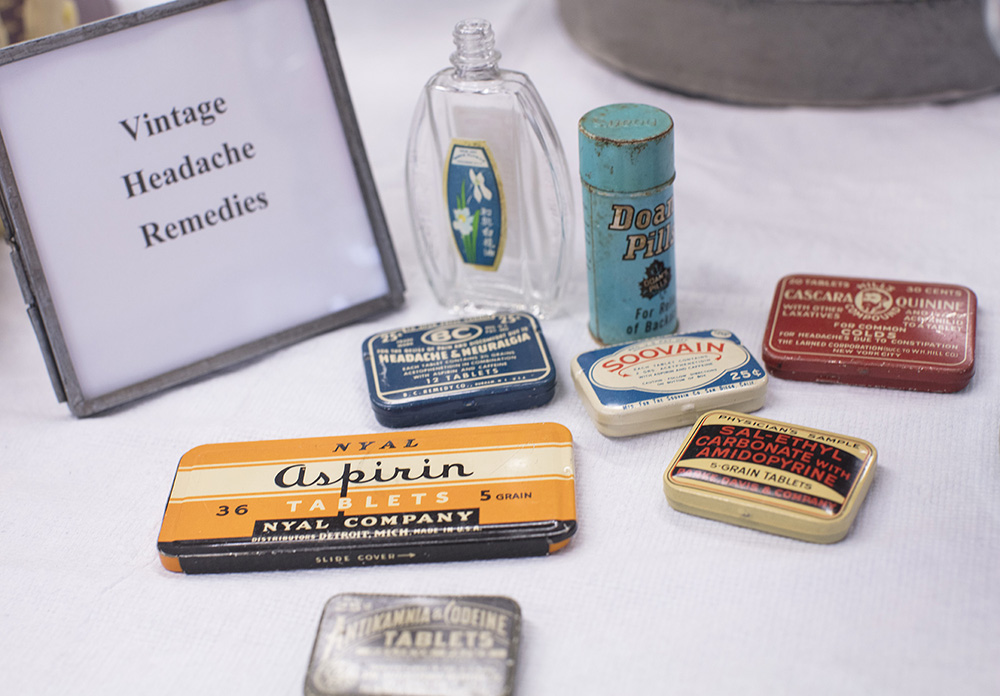Vintage containers for headache remedies ready for an upcoming exhibit.
