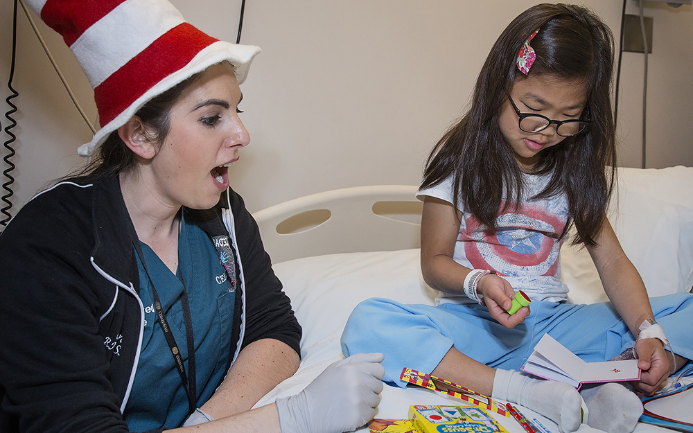 Chiara Casas, RN, with a Cedars-Sinai pediatric patient on Dr. Seuss’s birthday