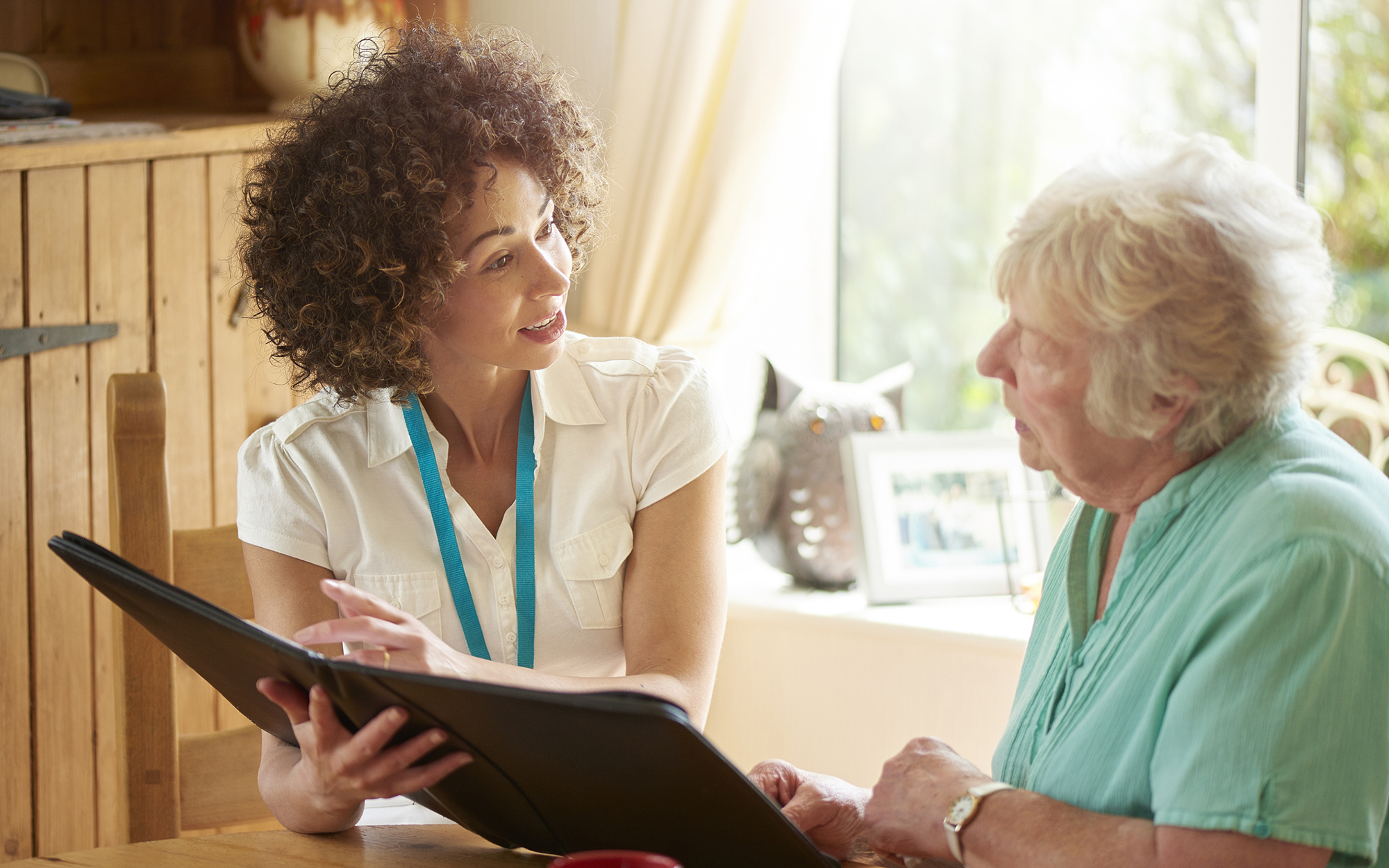 A Genetic counselor working with an older patient on her health journey.