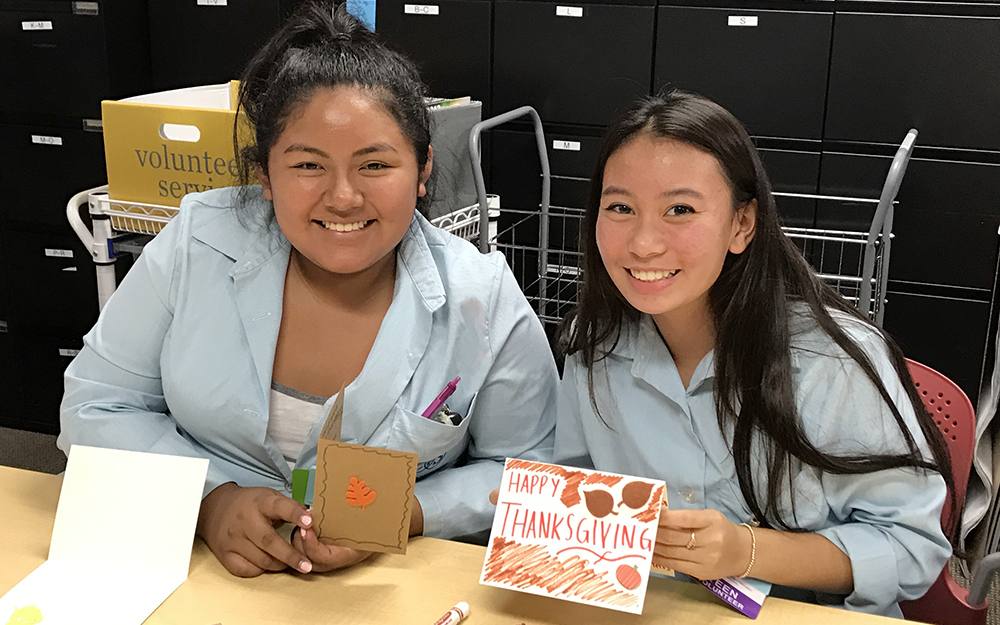 Teen volunteers creating holiday cards at Cedars-Sinai for patients