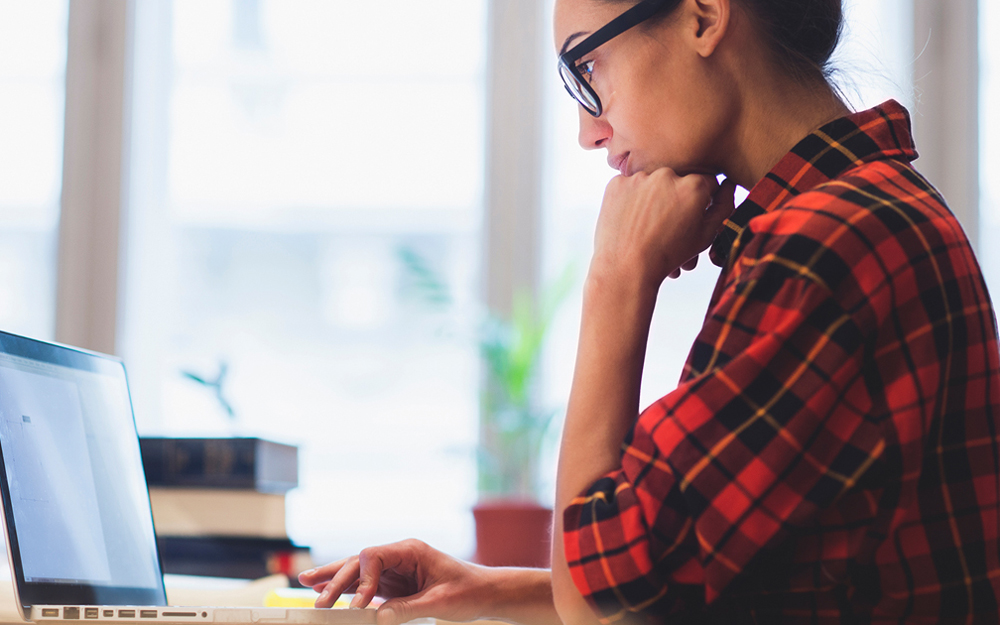 Woman looking at her laptop.
