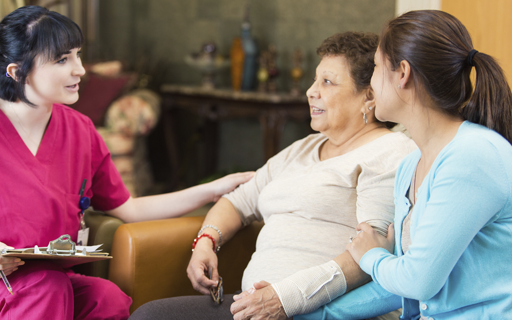 Two ladies talking to a nurse