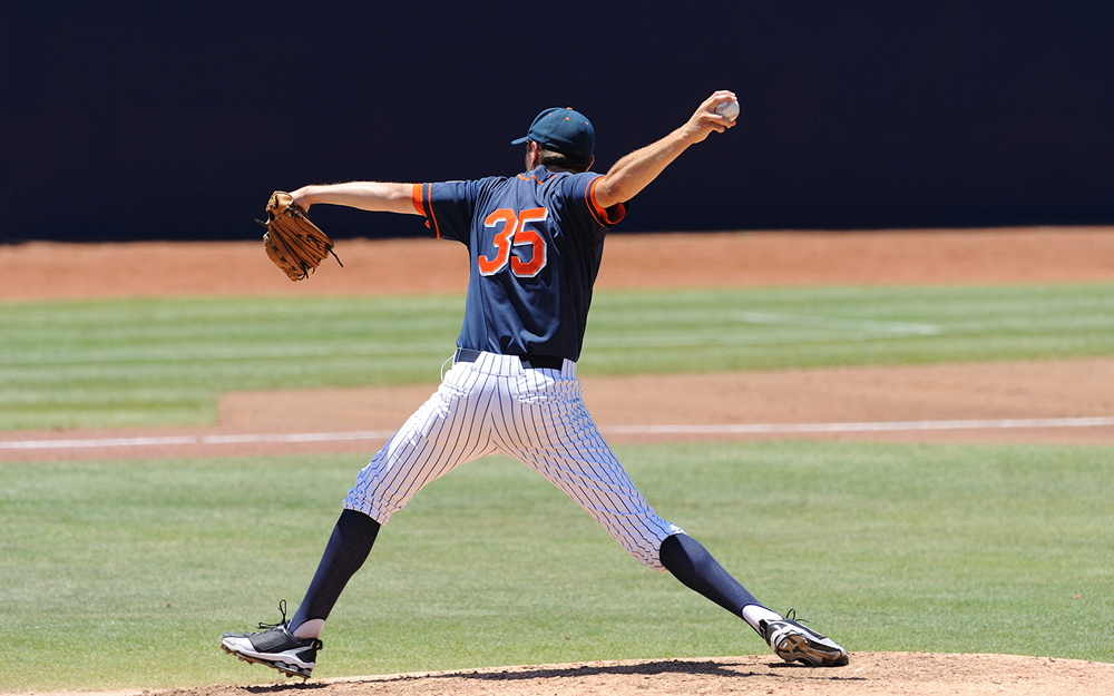 Baseball pitcher throwing a baseball.