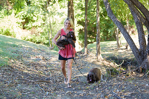 Patient Natalie Harris Brown on a walk with her two dogs.