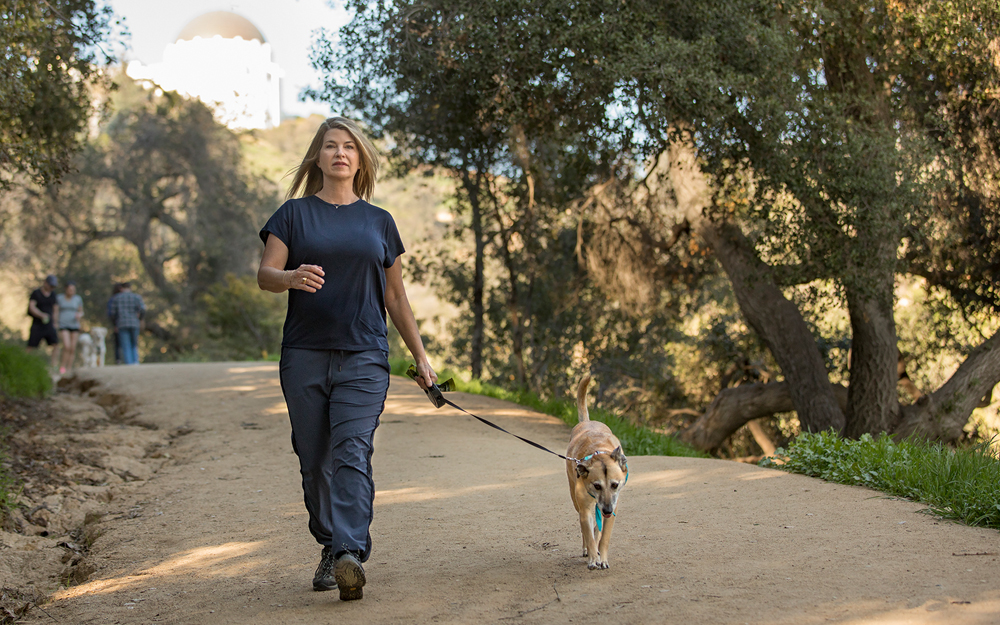 Cedars-Sinai patient Andrea Hill at the park with her dog after her treatment for menopause.