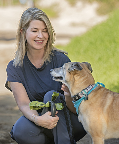 Menopause patient Andrea Hill at the park with her dog.