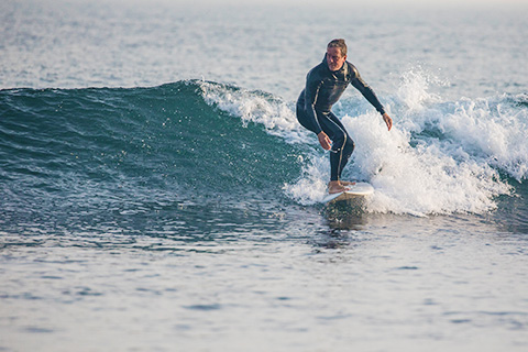 Linden Ashby surfing.