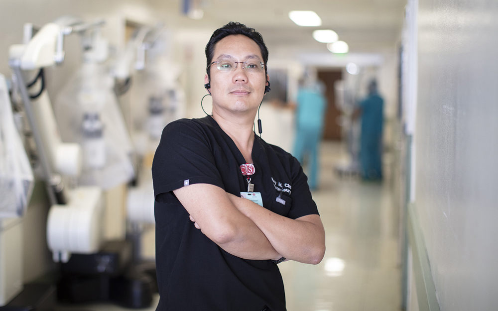 Dr. Ray Chu listening to earbuds in the halls of Cedars-Sinai.