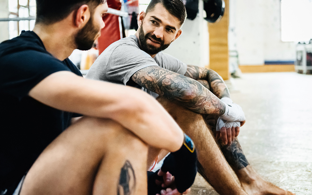 Friends talking in a gym.
