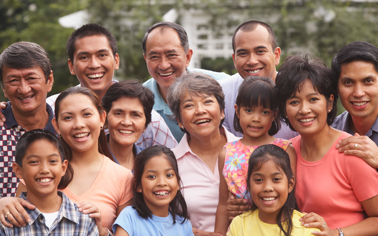 A family smiling and hugging each other