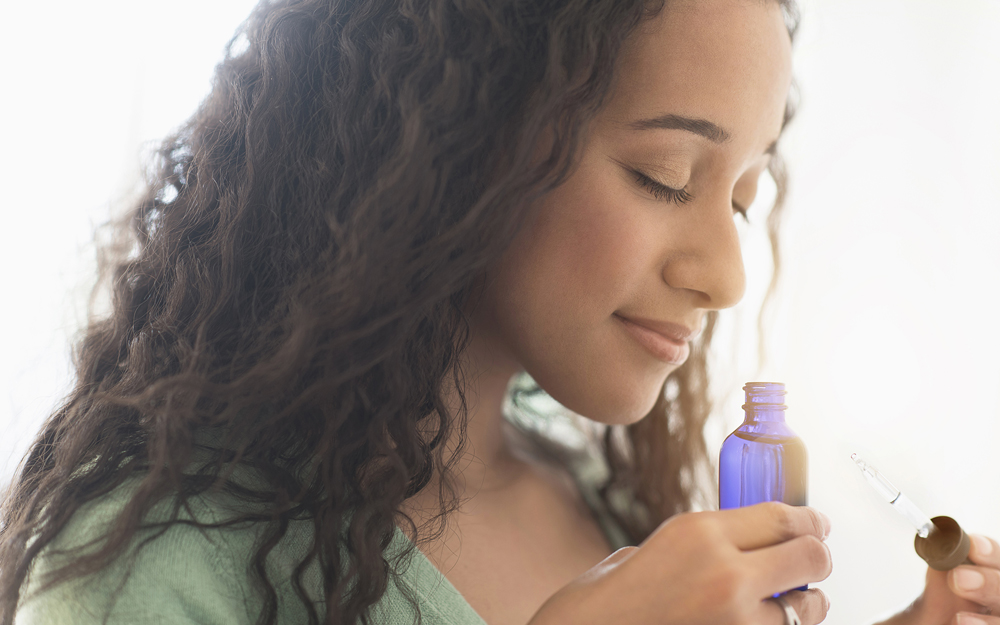 A woman smelling an essential oil