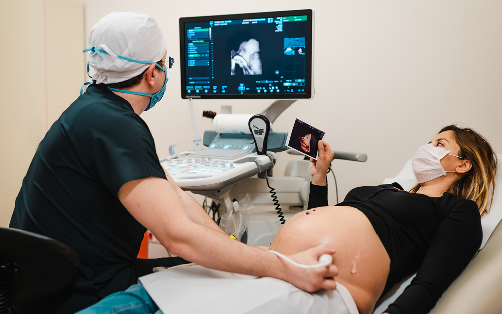 A pregnant woman getting an ultrasound during the COVID-10 pandemic.