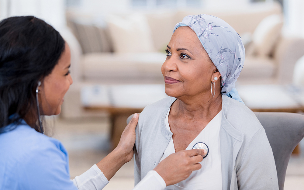 Doctor checking woman's heart beat