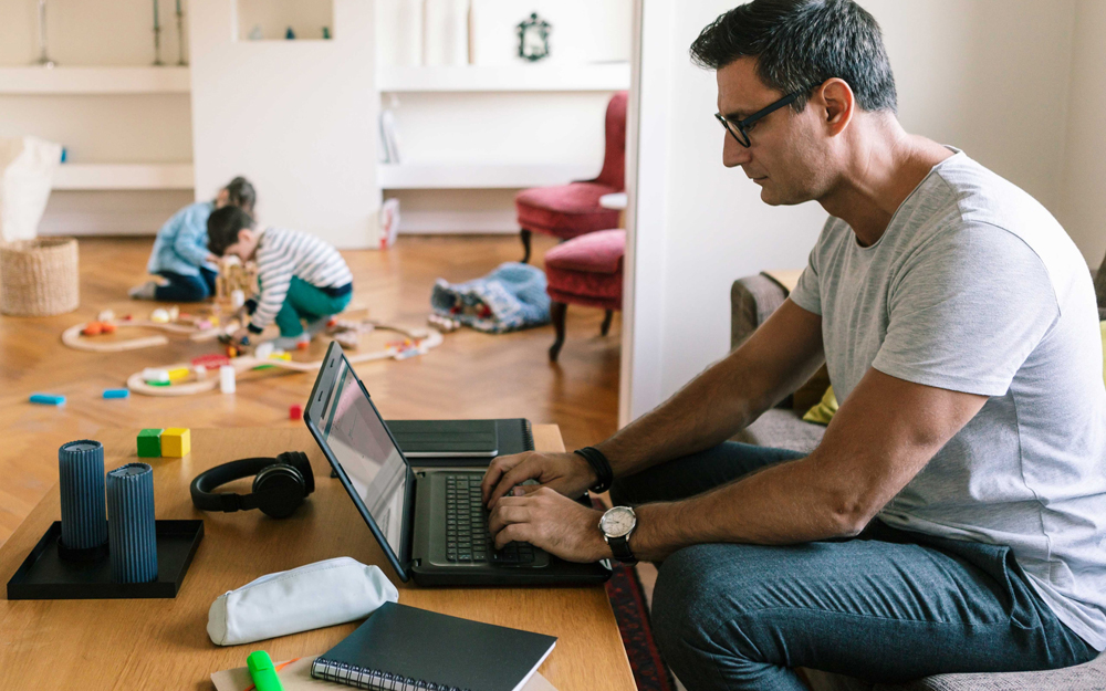 A man sitting at the couch for long periods of time might begin suffering from ergonomic injuries.