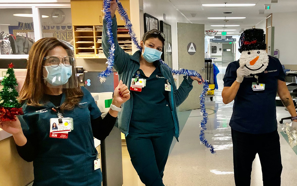 Cedars-Sinai employees holding decorations