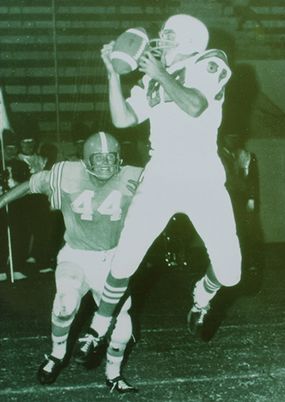 Artist Ken Brenner playing football at Long Beach State University.