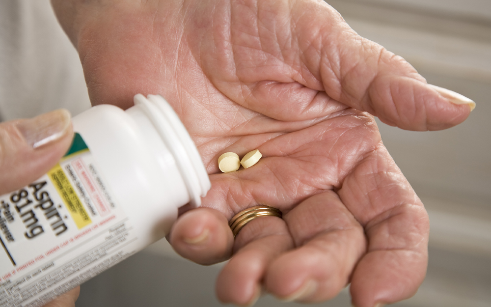 A couple of aspirin pills in a hand