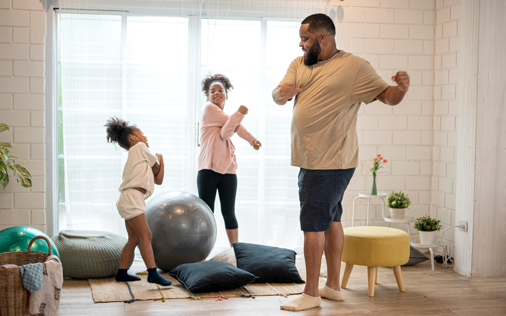 A family exercising in their living room during the COVID-19 pandemic.