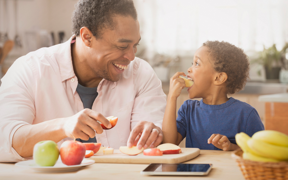 A family enjoys a healthy snack of fruits and vegetables.