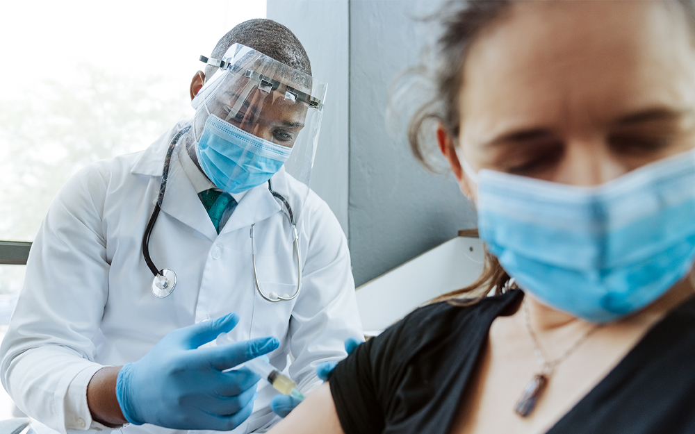 A person getting vaccinated while overcoming the fear of needles.