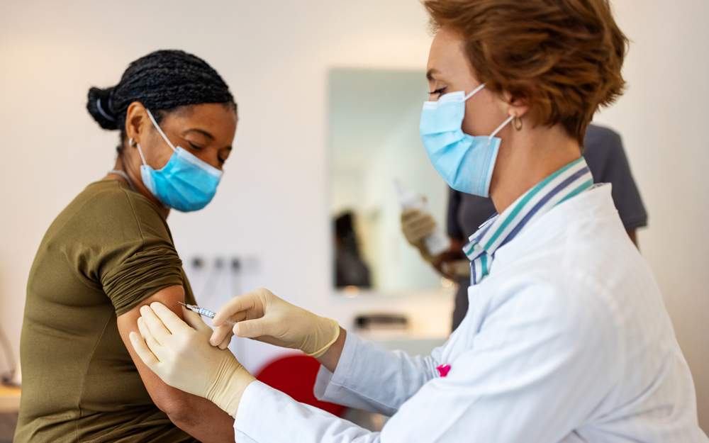 A patient receiving a COVID-19 vaccination from a healthcare professional.