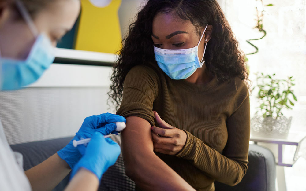 A worried women getting her Covid-19 vaccine.