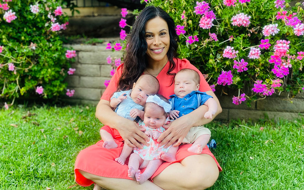 Rommy Coutelin holding her 3 babies.