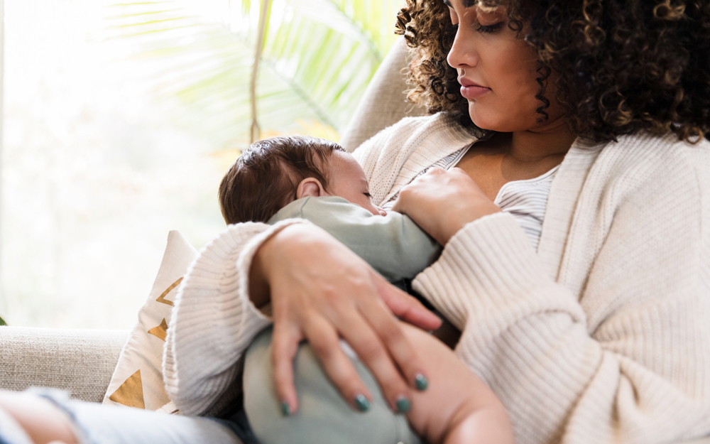 A woman nursing a newborn passing her COVID-19 immunity to the baby.