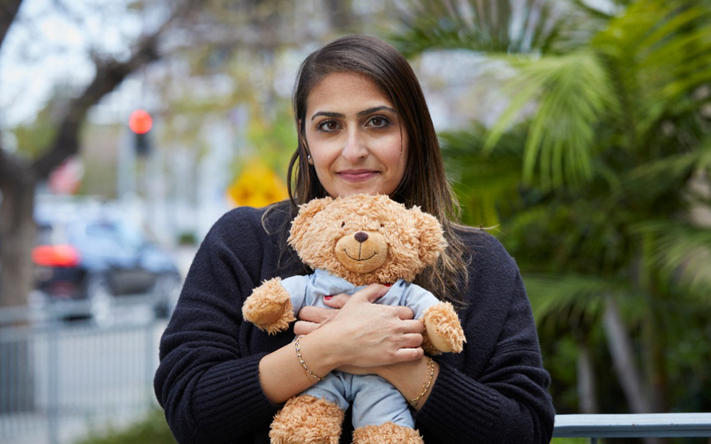 Paula Glashausser, Pediatric Social Worker holding a teddy bear.