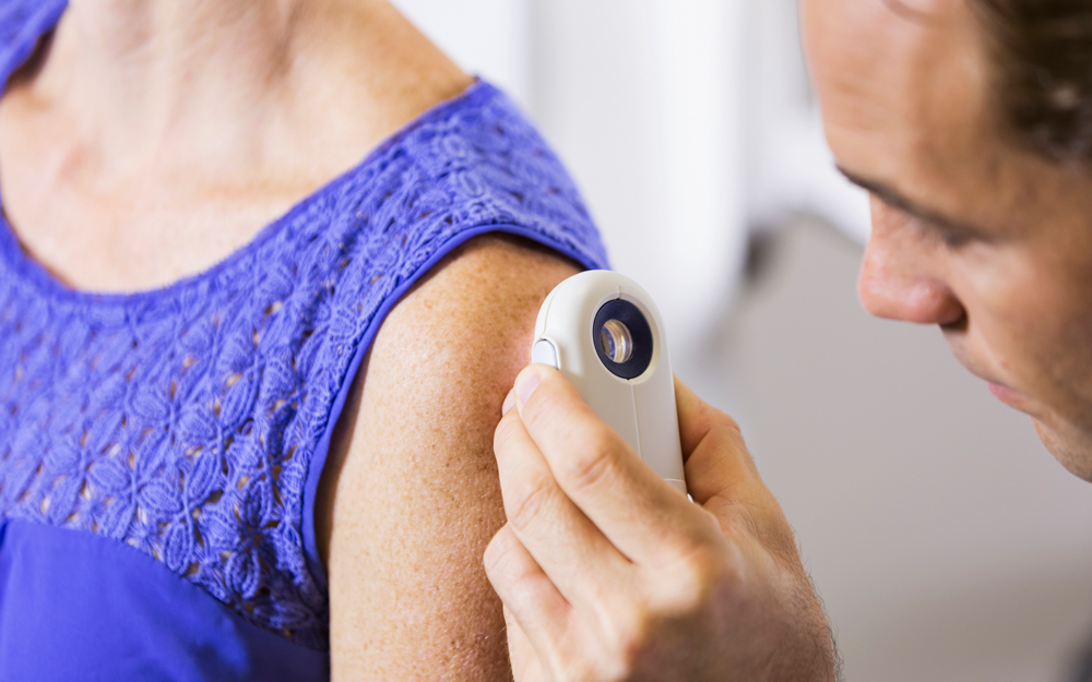 Woman getting her skin checked by a dermatologist.