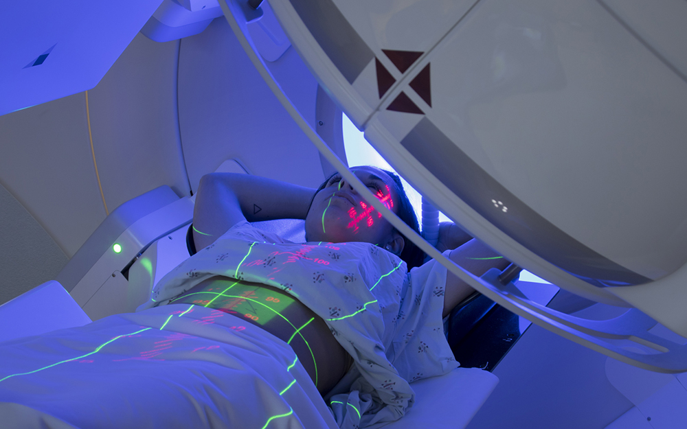 Woman receiving radiation therapy treatments.