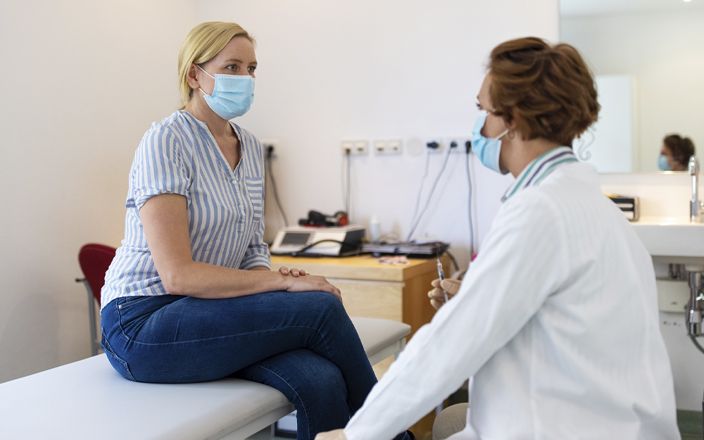 A doctor talking to the patient about vaccines