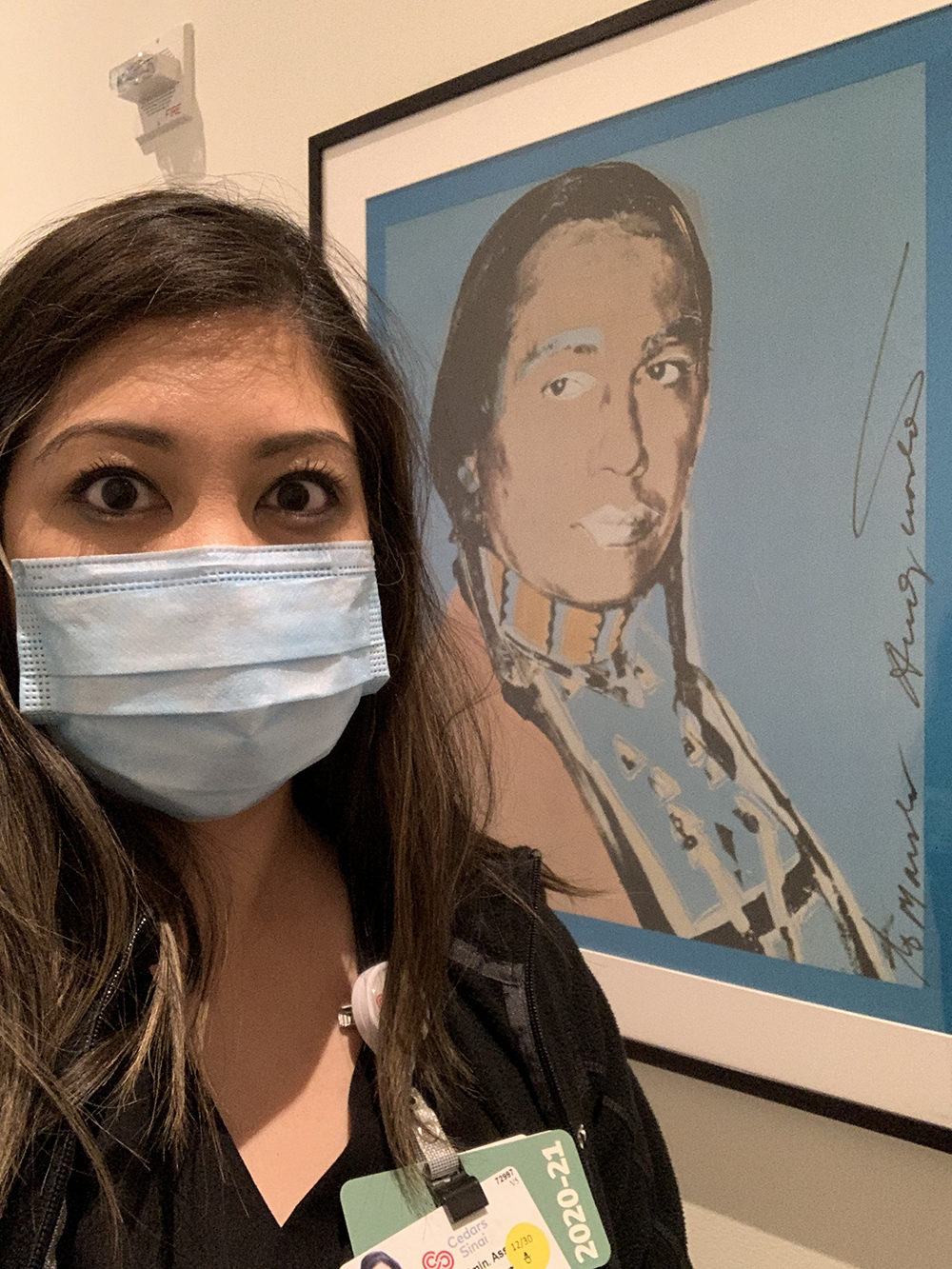 Christine J. Easterling, Lead Administrative Assistant of Capacity Management at Cedars-Sinai standing in front of Andy Warhol's art piece.