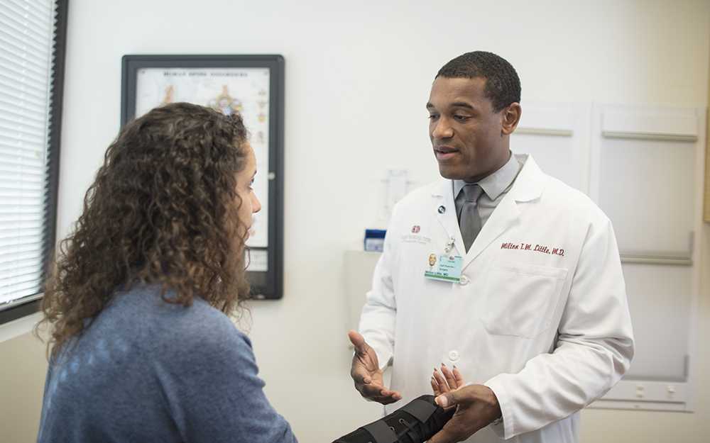 Milton Little, MD examines patient for orthopedics.