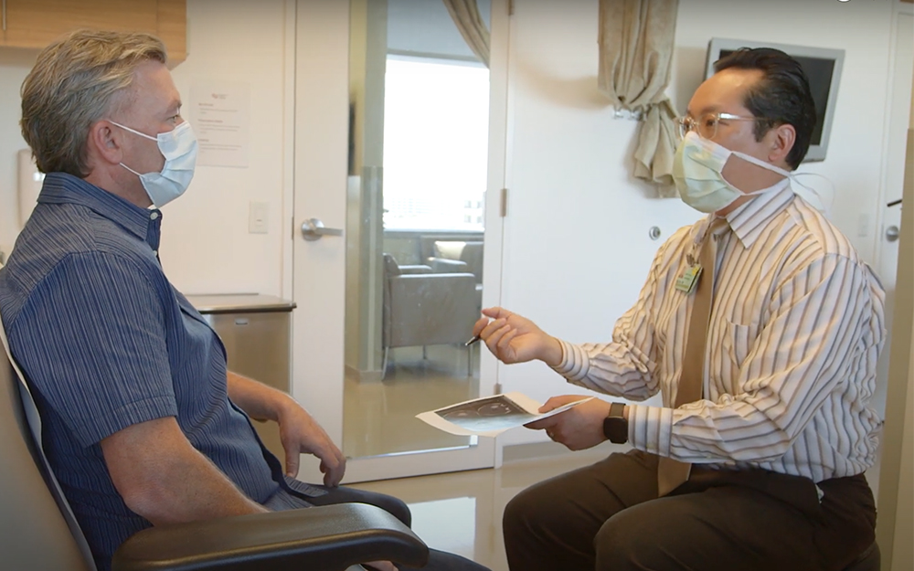 Dr. Ray Chu talking to Desmond in an office.