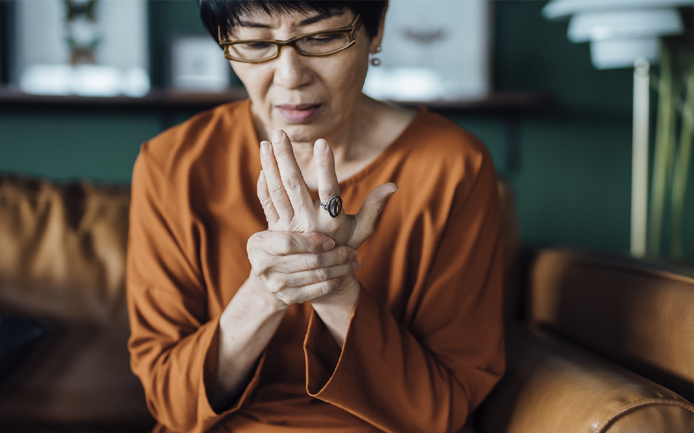 Elderly woman experiencing arthritis in the hand