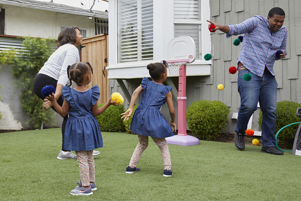 Premere Sessions with her two daughters and husband, Fletcher outside playing.