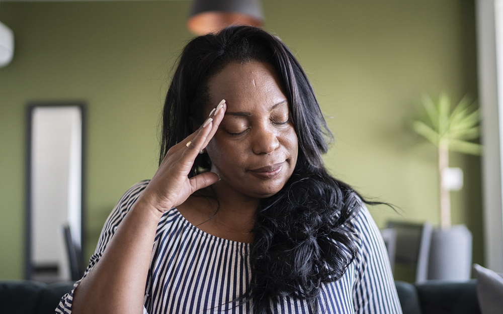 A black woman suffering from headaches