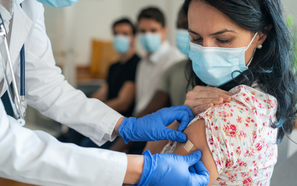 A female patient receiving an omicron or flu vaccine booster shot.