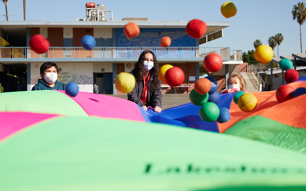 Anahi Luna playing bouncing balls with students.