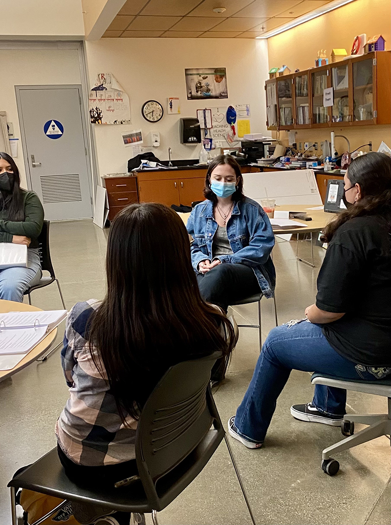  Group of teen line volunteers meeting in classroom.