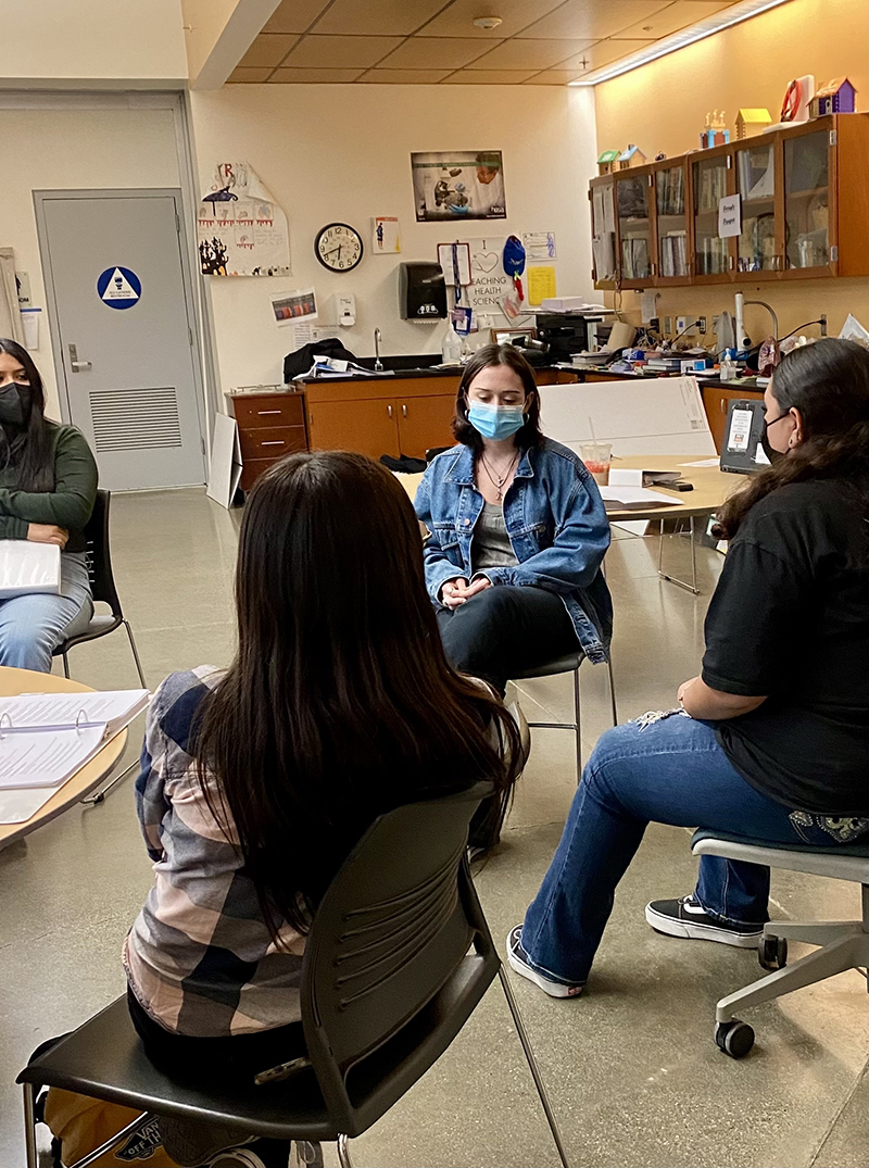 Group of teen line volunteers meeting in classroom.
