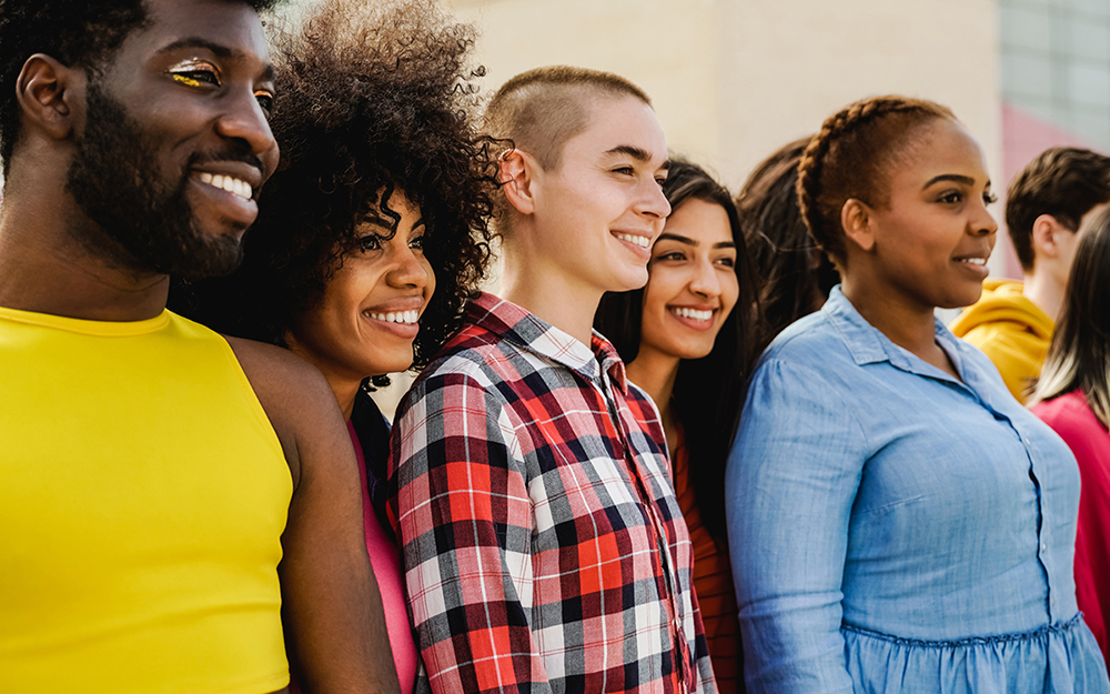 Multiethnic diverse group of people having fun outdoor - Focus on African girl face - Diversity and youth concept