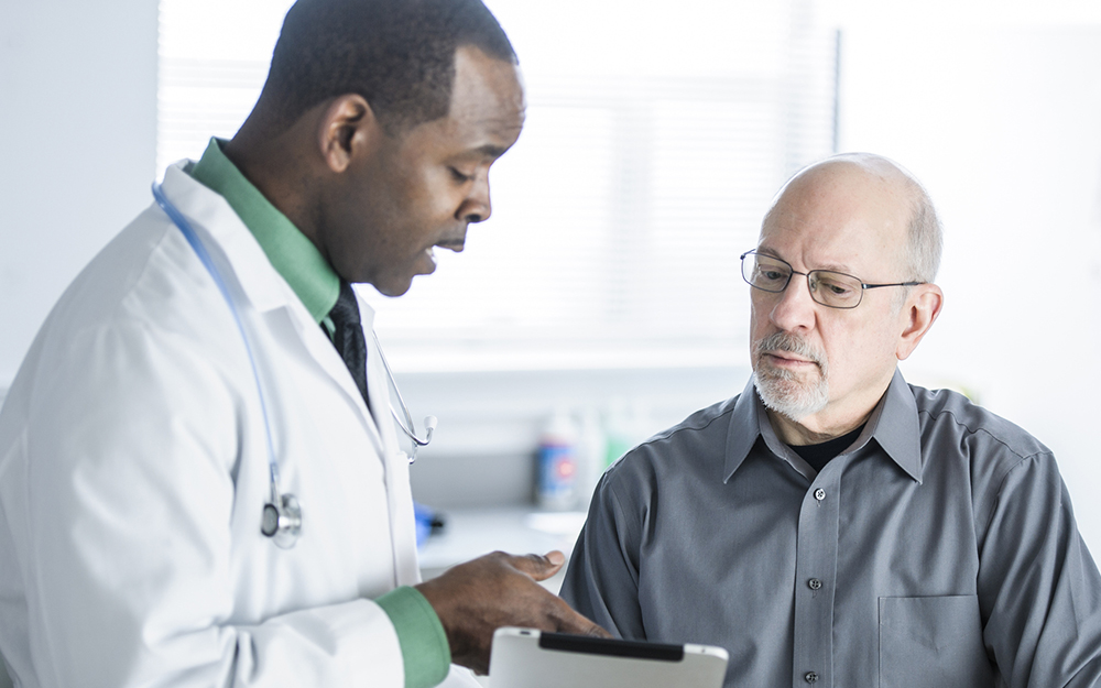 African American doctor talking to patient in office