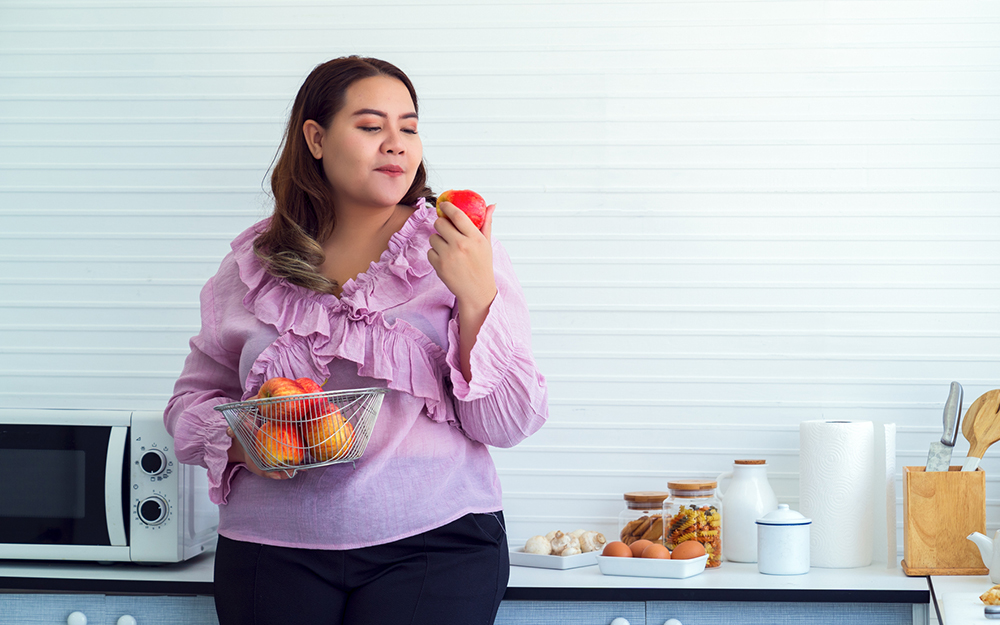 Portrait of young woman holding apple